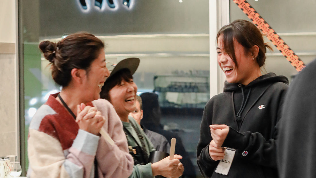 Interactive coffee training session at C Market Coffee, with participants engaging hands-on in latte art pouring and espresso-making techniques.