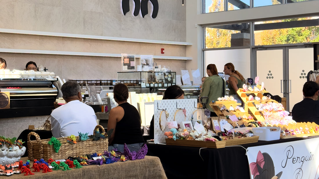 Vibrant and bustling pop-up market with various vendors showcasing their products and customers exploring the booths at C Market Coffee.