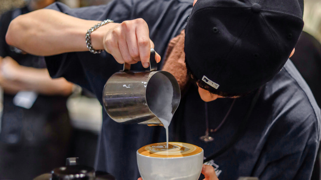 Coffee training session in progress at C Market Coffee, with participants practicing latte art and barista skills in a professional setting.